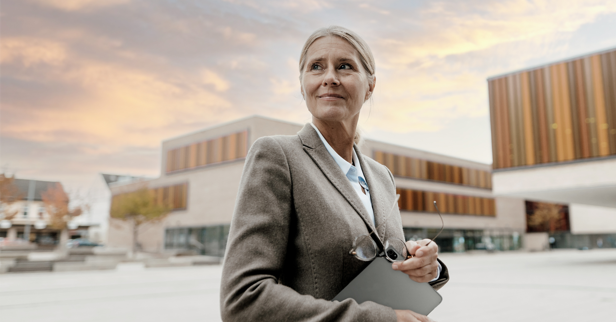 woman in a suit with a campus background